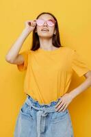 young beautiful woman in a yellow t-shirt emotions summer style isolated background photo