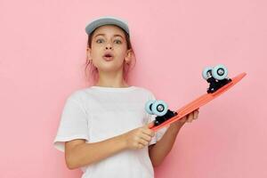 Portrait of happy smiling child girl with a skateboard in hand childhood unaltered photo