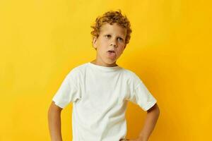 boy with curly hair childhood posing yellow background photo