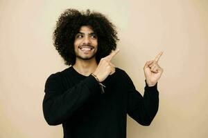 handsome man in a black sweater hand gesture Lifestyle unaltered photo