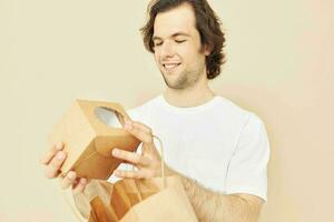 Cheerful man paper grocery bag posing Lifestyle unaltered photo