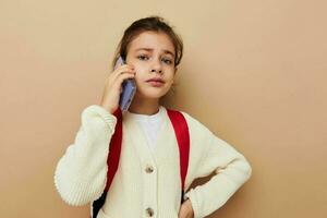 pretty young girl schoolgirl backpack phone in hand childhood unaltered photo