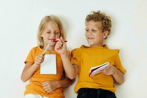 Boy and girl emotions drawing together notepad and pencils isolated background unaltered photo