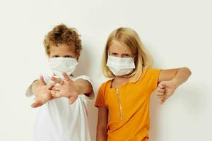 Cute stylish kids fun medical mask stand side by side close-up lifestyle unaltered photo
