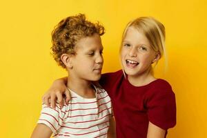 two joyful children standing side by side posing childhood emotions isolated background photo