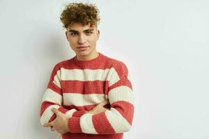 handsome guy in a striped sweater posing isolated background photo