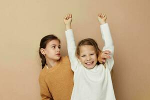 two cute little girls hug friendship lifestyle beige background photo