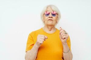 smiling elderly woman in fashionable glasses hand gestures close-up emotions photo