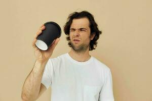 Attractive man with a black glass in a white t-shirt isolated background photo