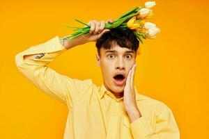 Photo of romantic young boyfriend with a fashionable hairstyle in yellow shirts with flowers Lifestyle unaltered