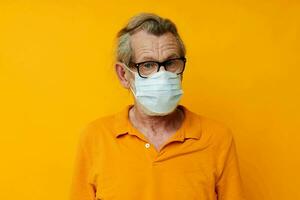 elderly man medical mask on the face protection close-up isolated background photo