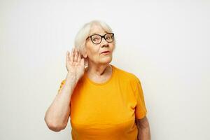 Portrait of an old friendly woman vision problems with glasses light background photo