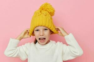 pretty young girl in a sweater and a hat isolated background photo