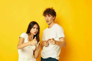 cute young couple posing together in white t-shirts friendship isolated background unaltered photo