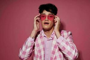 pretty man in pink glasses pink blazer posing studio Lifestyle unaltered photo