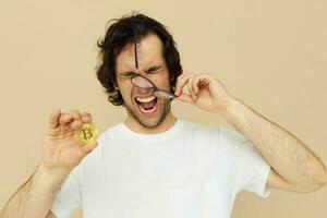 handsome man in a white T-shirt with Bitcoin cryptocurrency Lifestyle unaltered photo