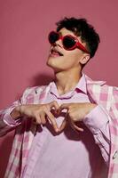 portrait of a young man sunglasses pink blazer fashion elegant style isolated background unaltered photo