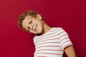 cute boy with curly hair in striped t-shirt emotions photo