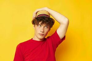 portrait of a young curly man in a red t-shirt with a fashion hat Lifestyle unaltered photo