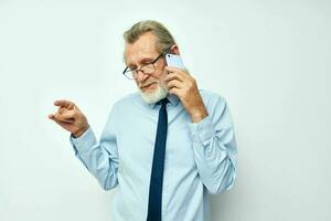 Photo of retired old man talking on the phone business work isolated background