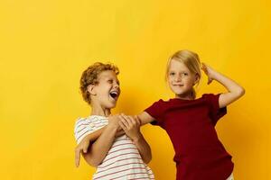 cheerful children cuddling fashion childhood entertainment yellow background photo