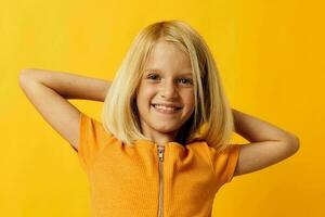 kid girl in a yellow t-shirt smile posing studio isolated background unaltered photo