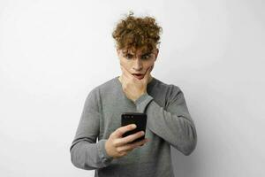 kinky guy with a phone in hand communication isolated background photo