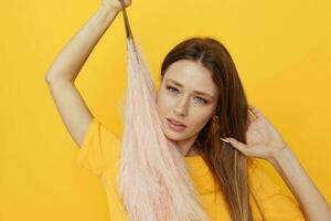 portrait of a young woman posing pink feathers in hands charm fashion yeah isolated background photo