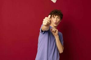 cute teen in purple t-shirts medical mask in hands safety red background unaltered photo