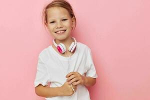 Portrait of happy smiling child girl smile posing headphones isolated background photo