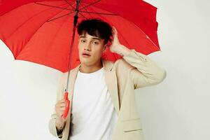 Man holding an umbrella in the hands of posing fashion light background unaltered photo
