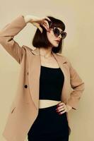 beautiful woman in sunglasses short haired suit gesturing with hands Lifestyle unaltered photo