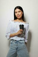 Charming young Asian woman in a white shirt a glass with a drink posing isolated background unaltered photo