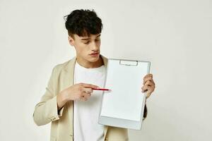 Man in a beige suit copy-space notebook isolated background unaltered photo