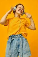 beautiful woman yellow t-shirt headphones entertainment music fun isolated backgrounds unaltered photo