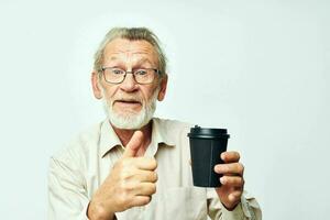 Portrait elderly man in a shirt and glasses a black glass isolated background photo