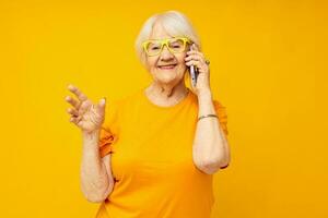 smiling elderly woman fun talking on the phone isolated background photo