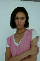 cute short haired brunette pink vest posing fashion photo