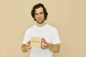 emotional man with gift small box on beige background photo