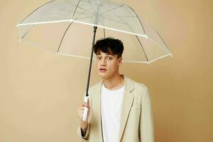 nice guy in a jacket with an open umbrella protection from the rain photo