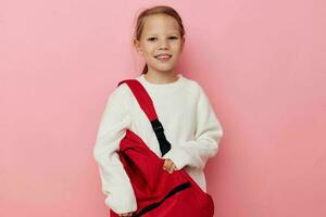 little girl with a red backpack fun isolated background photo