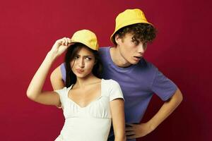 young man and girl in yellow hats posing together friendship isolated background photo