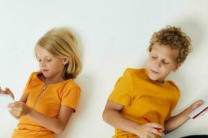 Cute stylish kids drawing in notebooks lying on the floor childhood lifestyle unaltered photo