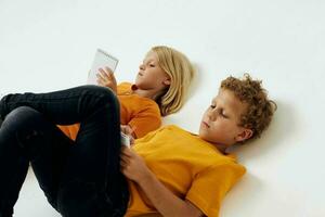 cheerful children lie on the floor with notepads and pencils childhood lifestyle unaltered photo