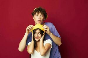 Man and woman in yellow hats posing together friendship isolated background photo