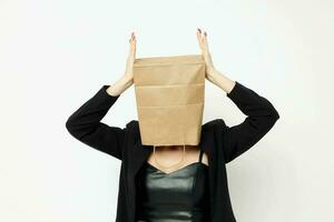 portrait of a woman with a bag on his head in a black jacket red nail polish isolated background photo