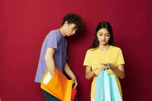 cute young couple in colorful T-shirts with bags Shopping Lifestyle unaltered photo