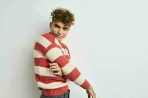 handsome guy in a striped sweater posing Lifestyle unaltered photo