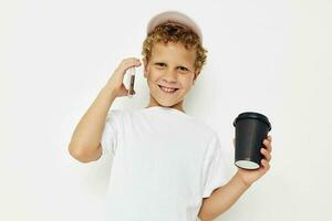 Cute little boy what kind of drink is the phone in hand communication light background unaltered photo