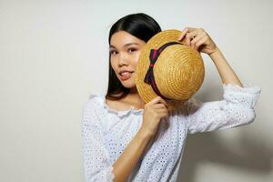 Charming young Asian woman in white shirts hat fashion posing isolated background unaltered photo